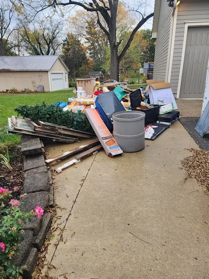 Dumpster being loaded with debris for Estate Cleanout Dumpster Rental in Experiment